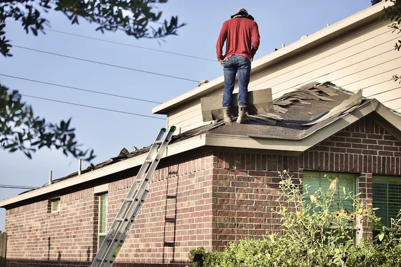 Professional roofer working on a residential roof in Clement